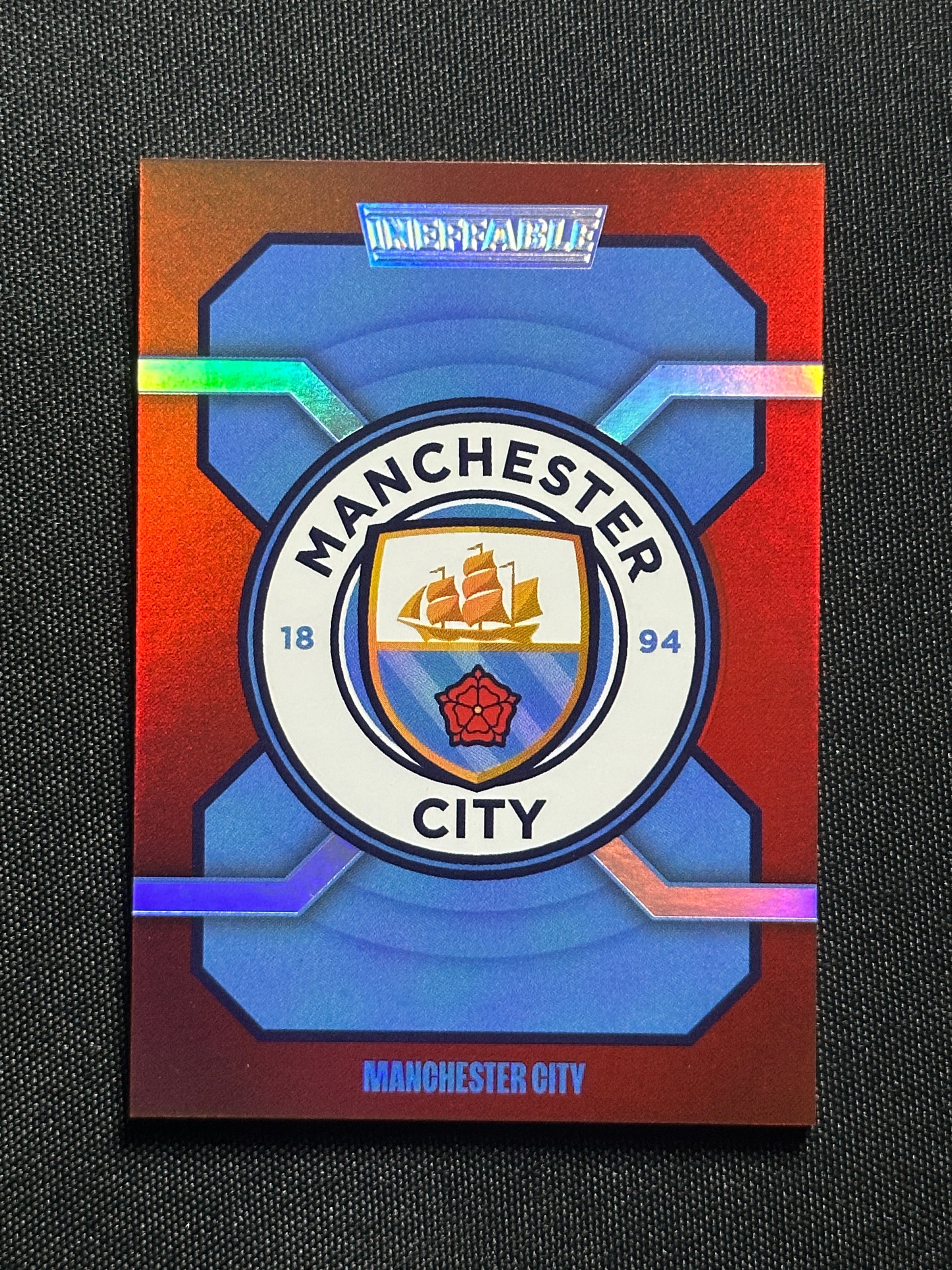 Badge Numbered Parallel 44/99 - Daka Manchester City Ineffable 2023/24